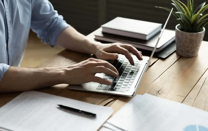 A foreign worker signing insurance registration documents.